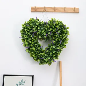 Artificial eucalyptus heart wreath for wall and door hanging home decor detail view.