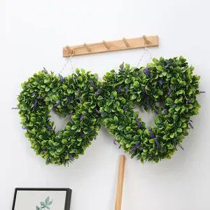 Close up detail of artificial eucalyptus heart shaped wreath with purple lavender accents.