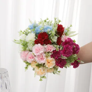 Detailed view of colorful artificial carnation bouquet with green leaves for home decor and gifts.