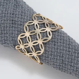 Gold metal napkin ring close-up detail, hollow geometric table setting decorative cloth ring