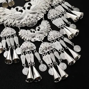 Exaggerated retro silver peacock necklace with bell pendants, ethnic costume jewelry accessory.