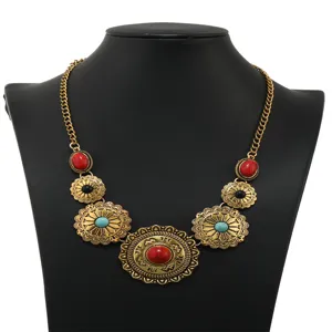 Vintage turquoise statement necklace close up, boho floral pendant metal jewelry detail.