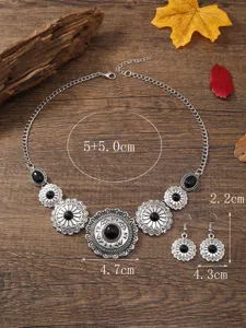 Vintage floral black stone statement necklace and matching earrings detail display.