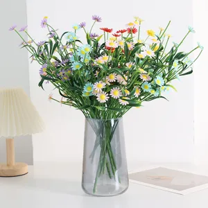 Close-up detail of artificial daisy bouquet in glass vase, elegant home decor arrangement.