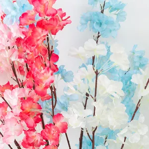 Artificial cherry blossom branch details, colorful floral decoration for events and weddings.