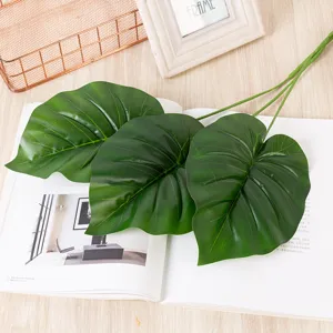 Feuilles de monstera artificielles, tiges de plantes vertes pour décoration intérieure.