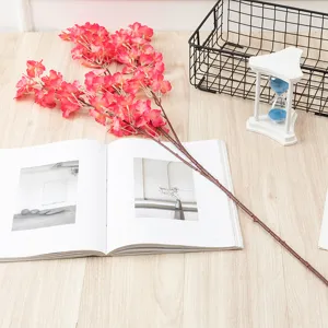 Artificial cherry blossom branch detail, pink silk flowers and realistic brown stem for decor.