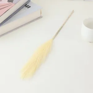 Detail shot of artificial pampas grass stem in soft yellow, perfect for home decor and floral styling.