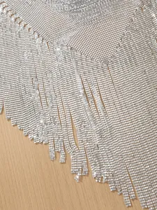 Silver sequin tassel belly dance hip scarf detail, shimmering metal mesh waist chain design.