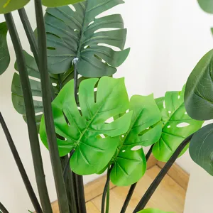 Primo piano dettagliato di foglie di monstera artificiali con trame realistiche per decoro.