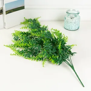 Artificial Boston fern plant detail shot, green plastic leaf branch for home room decor.