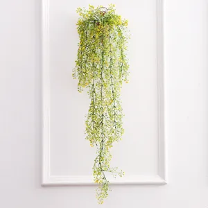 Artificial hanging plant detail view, featuring delicate yellow flowers and green cascading vines.