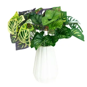 Artificial monstera plant potted in white ceramic vase for home decor interior styling setup.