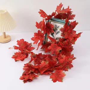 Artificial maple leaf vine garland detail shot, autumn home decor plant hanging decoration.
