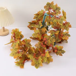Artificial maple leaf vine for autumn and Halloween decor, detailed view of the hanging plant garland.