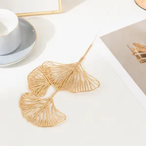 Golden artificial ginkgo leaf branch for home decoration and festival floral arrangement.