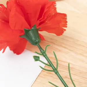 Artificial carnation flower detail close-up showing silk petals and stem structure.
