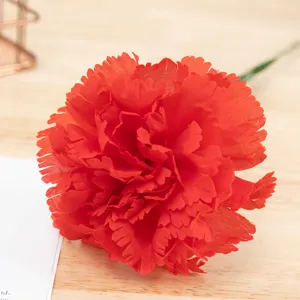 Close-up detail of artificial red carnation flower silk material home decor floral arrangement