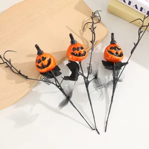 Halloween smiling pumpkin branch ornament bouquet with black leaves for holiday party decor.