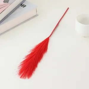 Red artificial pampas grass detail shot, perfect for home decor and wedding arrangement.