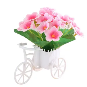 Artificial flower potted plant in a white bicycle holder, perfect for home desktop decor.