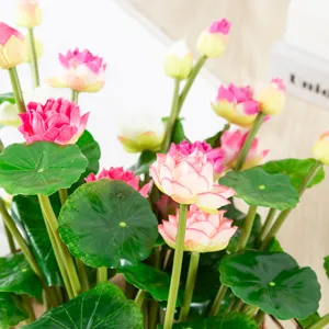 Detailed close-up view of artificial lotus flowers and green leaves, perfect for home decor.