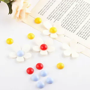 Acrylic white flower charms and colorful round cabochons for DIY handmade jewelry crafts.