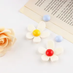 Close-up of colorful acrylic flower DIY jewelry accessories, charming handmade craft charms detail.