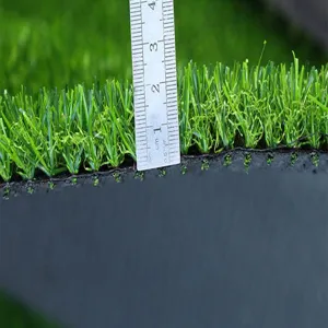 Closeup view of artificial grass turf pile height showing dense green blades and black backing base.