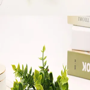 Artificial eucalyptus plant detail, realistic plastic green leaves for home decoration.