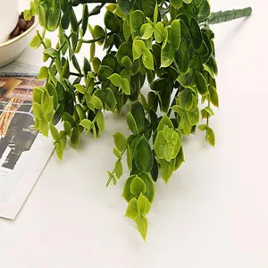 Artificial eucalyptus leaf branch detail, plastic greenery for floral arrangement decor.