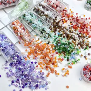 Colorful glass seed and bugle beads set in tubes for DIY handmade jewelry crafting.