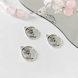 Silver rose metal charms detailed close-up showing exquisite floral design and compact size.