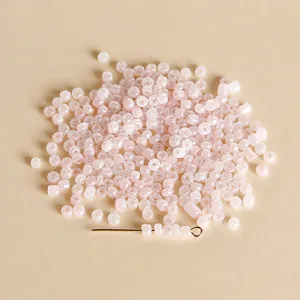 Close-up detail of 3mm jelly pink seed beads, perfect for DIY jewelry making and bracelets.