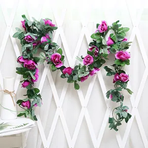Detailed view of artificial rose flower vine with purple silk roses and lush green leaves.