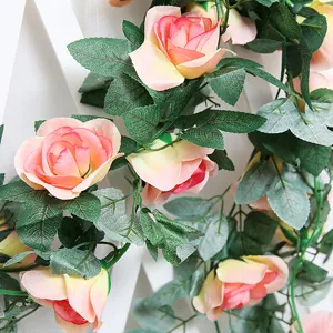 Detailed close-up of artificial rose garland, silk flower vine for wedding decor and hotel setup.