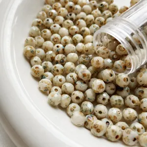 Detail view of 6mm Czech fire polished faceted beads with Picasso finish for DIY jewelry craft.