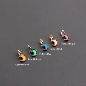 Detail view of small enamel moon charms, colorful alloy DIY jewelry pendants for earrings.