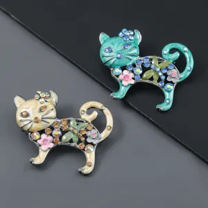 Close-up detail of rhinestone enamel cat brooch set, vintage fashion accessories and gifts.