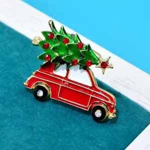 Detailed view of a festive alloy Christmas tree on red car brooch with sparkling rhinestones.