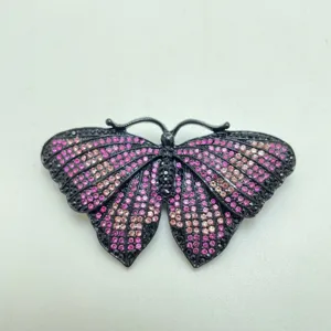 Detail shot of vintage butterfly brooch with sparkling pink and purple crystal rhinestones.