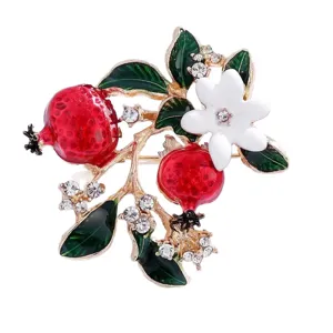 Elegant pomegranate brooch featuring vibrant red enamel fruits, green leaves and sparkling rhinestones.