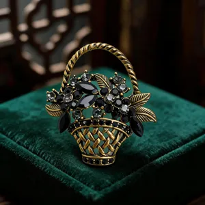 Close-up of a vintage gold flower basket brooch featuring sparkling black and clear rhinestones.