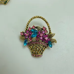 Vintage crystal flower basket brooch detail shot, antique gold tone with colorful rhinestones.