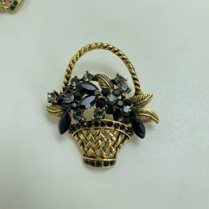 Vintage flower basket brooch featuring exquisite black crystal rhinestones and antique gold metal finish.