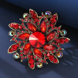 Close-up of vintage crystal flower brooch, sparkling red rhinestones, elegant detail shot.