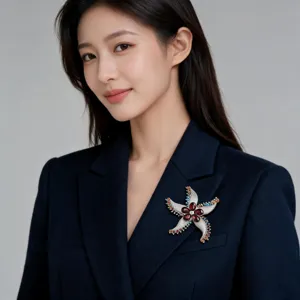 Detailed close-up view of luxury starfish brooch featuring colorful rhinestones on blazer.