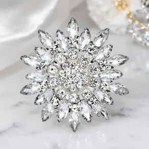 Detailed shot of the luxury crystal magnolia flower brooch featuring sparkling rhinestones.