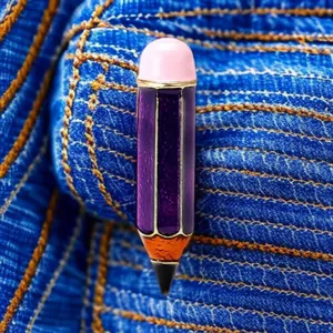 Primer plano detallado del broche creativo de esmalte con forma de lápiz en mezclilla.