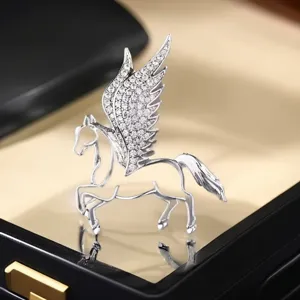 Exquisite winged horse brooch detail, micro-set cubic zirconia, elegant jewelry box scene closeup